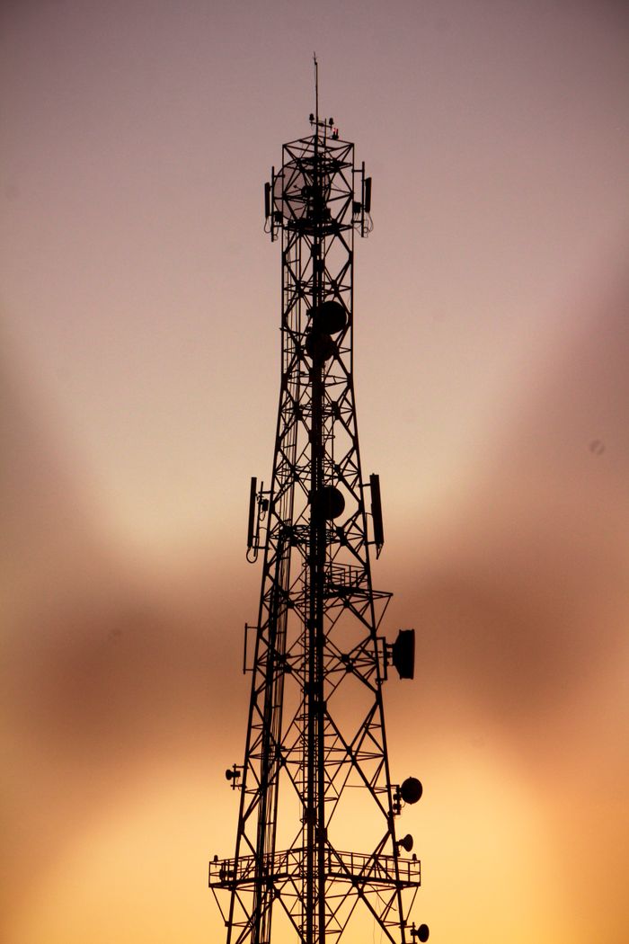 gallery-3 Telecom tower silhouette against a dramatic golden hour sky in Algeria.