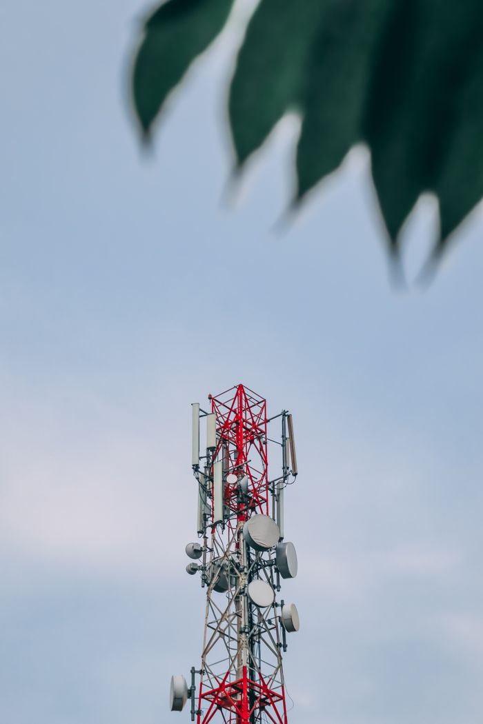 gallery-2 A telecommunications tower with antennas and dishes against a clear blue sky in Ulipur, Bangladesh.